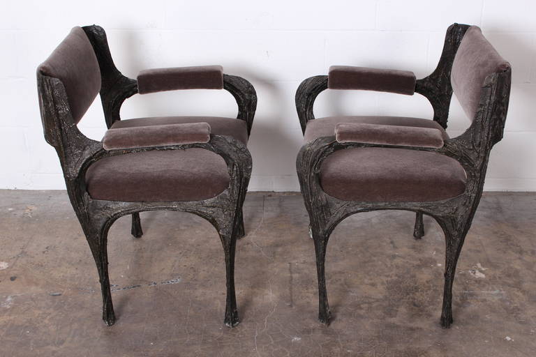 A pair of sculpted bronze armchairs designed by Paul Evans. Four matching side chairs also available. Newly upholstered in grey mohair.
