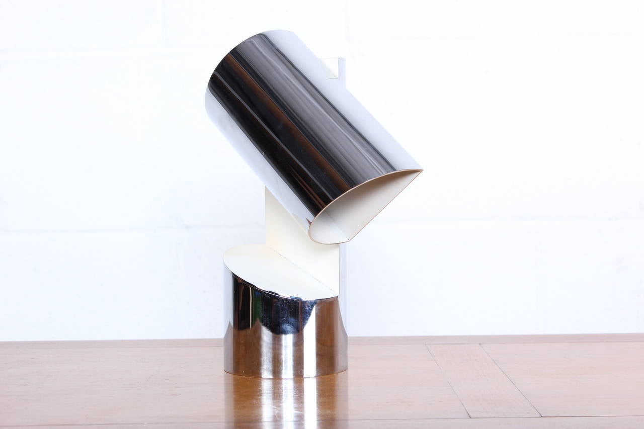 A pivoting chrome table lamp by Arredoluce.