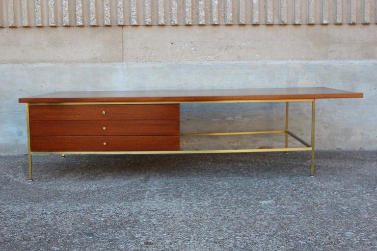 A Mahogany and brass coffee table designed by Paul McCobb for Calvin.