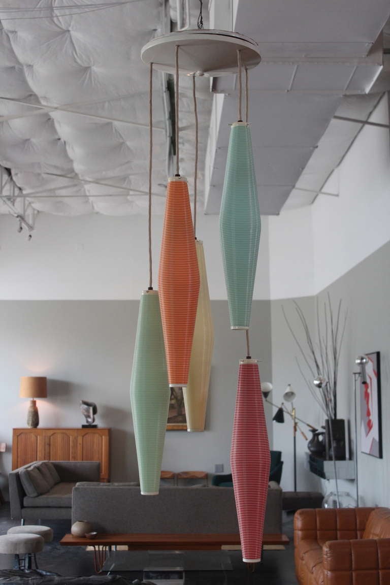A large five tier light fixture with each pendent being a different color. Manufactured by Rotaflex and distributed by the Heifetz Lighting Co. The cords can be lengthened to desired size.