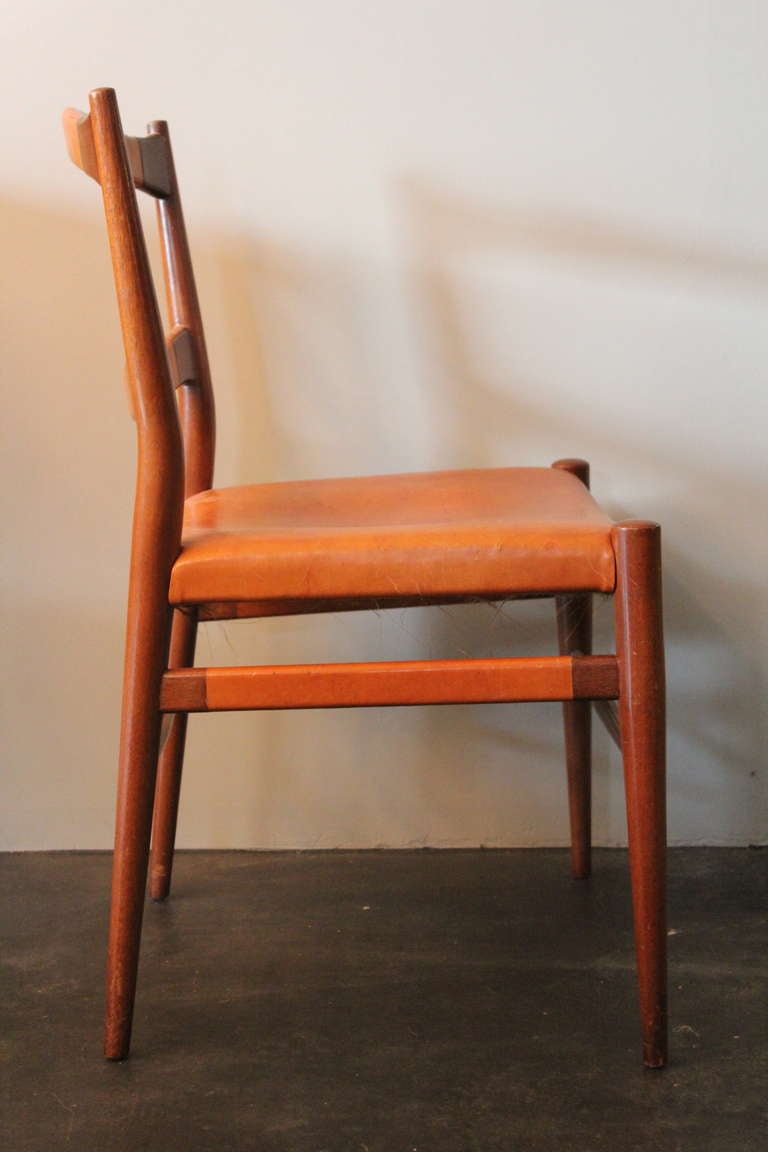 A beautifully patinated desk chair with leather wrapped back and sides.
