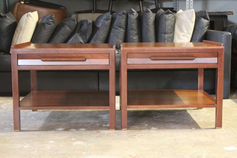 An oversized pair of walnut end tables with brass feet. Designed by Edward Wormley for Dunbar.