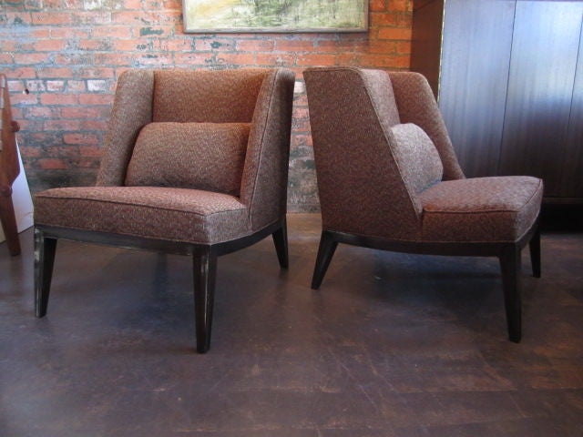 A pair of Dunbar lounge chairs #6017 designed by Edward Wormley. Beautifully sculpted mahogany base. Down pillows with leather piping.