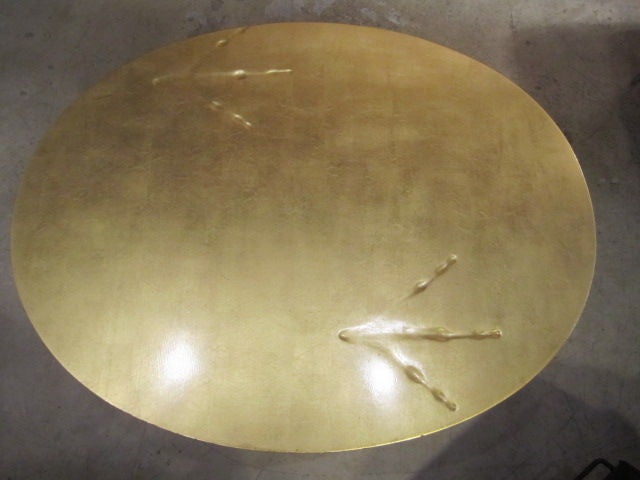 The Traccia patinated bronze base and gold leaf topped table designed by Meret Oppenheim in 1939. This version was made in the 1970's, probably by Simon Gavina.