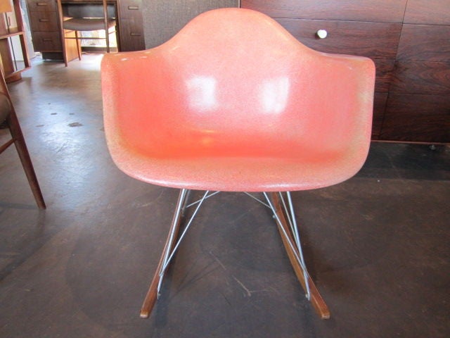 This is the best example of a Rocking chair designed by Charles Eames that we have seen. A very early Zenith/Herman Miller label. Salmon armshell with rope edge and beautiful patina. Museum quality.