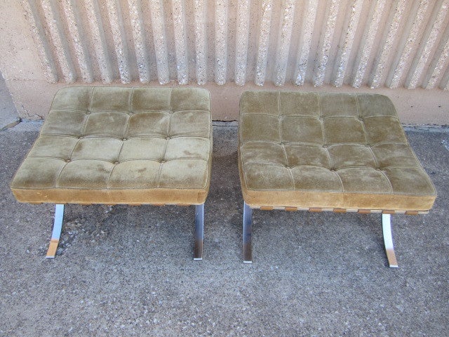 A matching pair of Knoll Barcelona ottomans designed by Mies Van Der Rohe. This pair dates to the early 70's and was custom ordered in brown suede which now has a wonderful patina.
