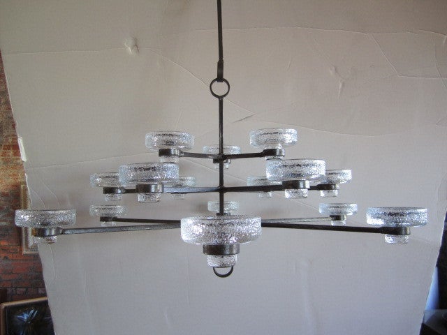 A simple iron and glass candelabra designed by Erik Hoglund. The candle holders can use three different size candles.