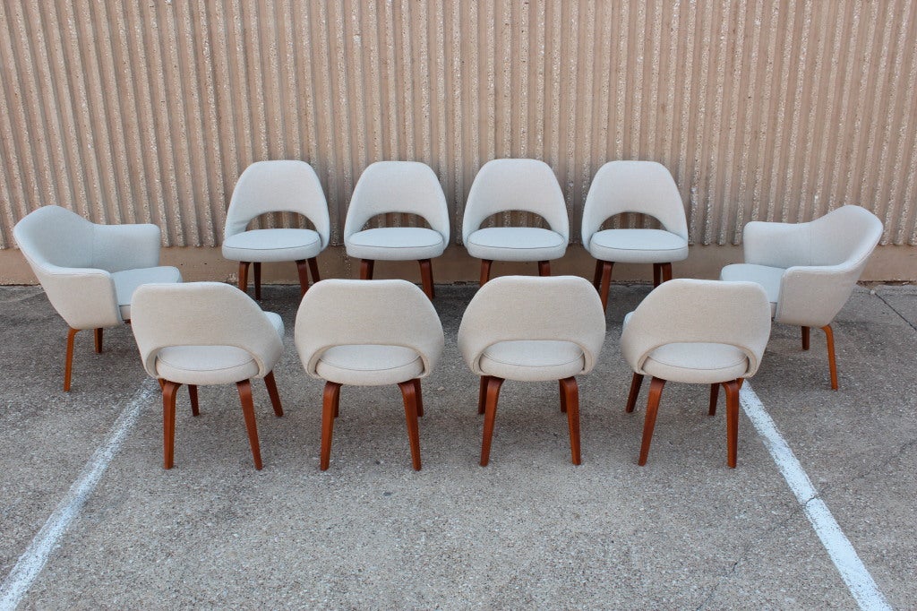 A large and early set of fully restored dining chairs designed by Eero Saarinen for Knoll. This rare set has original Teak bentwood legs. Upholstered in natural Linen.