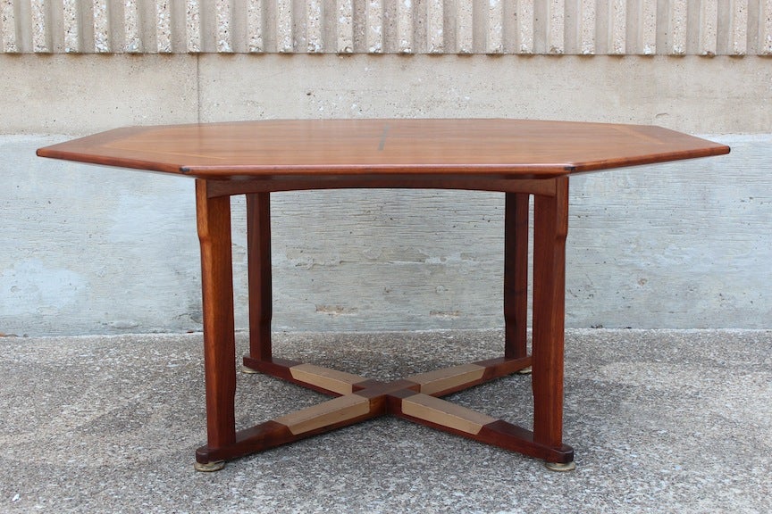 A large and exquisitely well made game/dining table designed by Edward Wormley for Dunbar. The table is made of sap walnut with rosewood inlay and solid brass glides. The base is wrapped in its original leather.