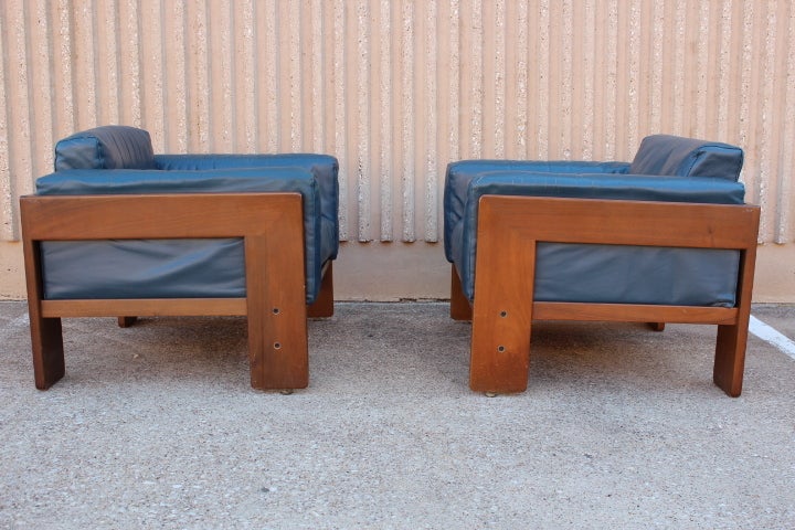 An early pair of Bastiano club chairs in original blue leather. Designed by Tobia Scarpa for Gavina. Matching sofa also available.