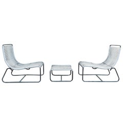 Pair of low lounge chairs and ottoman by Walter lamb