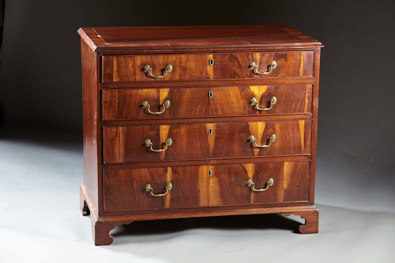 A charming and distinctive English, George III period chest of drawers in walnut. The crossbanded and molded edge top above four graduated drawers veneered in figural sap wood walnut and raised on well shaped bracket feet, English, circa 1780.
