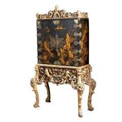 A Rare Chinoiserie Lacquered Cabinet on Carved Giltwood Base