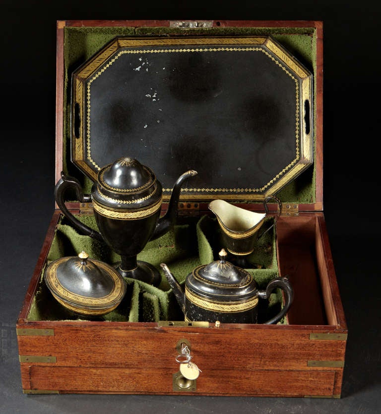 A rare boxed tole tea set. The Regency period mahogany lidded box with single drawer and original brass fittings houses a tole tea set with black and gold decoration. English Regency period, circa 1800.

Please contact gallery directly for