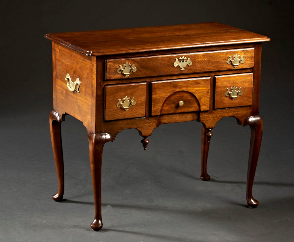 A Rhode Island or Massachusetts walnut lowboy with domed concave blocked apron and with notched and molded edge top. Brasses are replaced. The pendants appear to be original. RI or Mass., circa 1750-60. Ref.: I. Sack. Vol. 3, Pl. 3306, Pg 726.