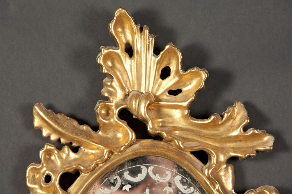 18th Century and Earlier A pair of Italian Giltwood Etched Mirrors with Sconce Arms For Sale