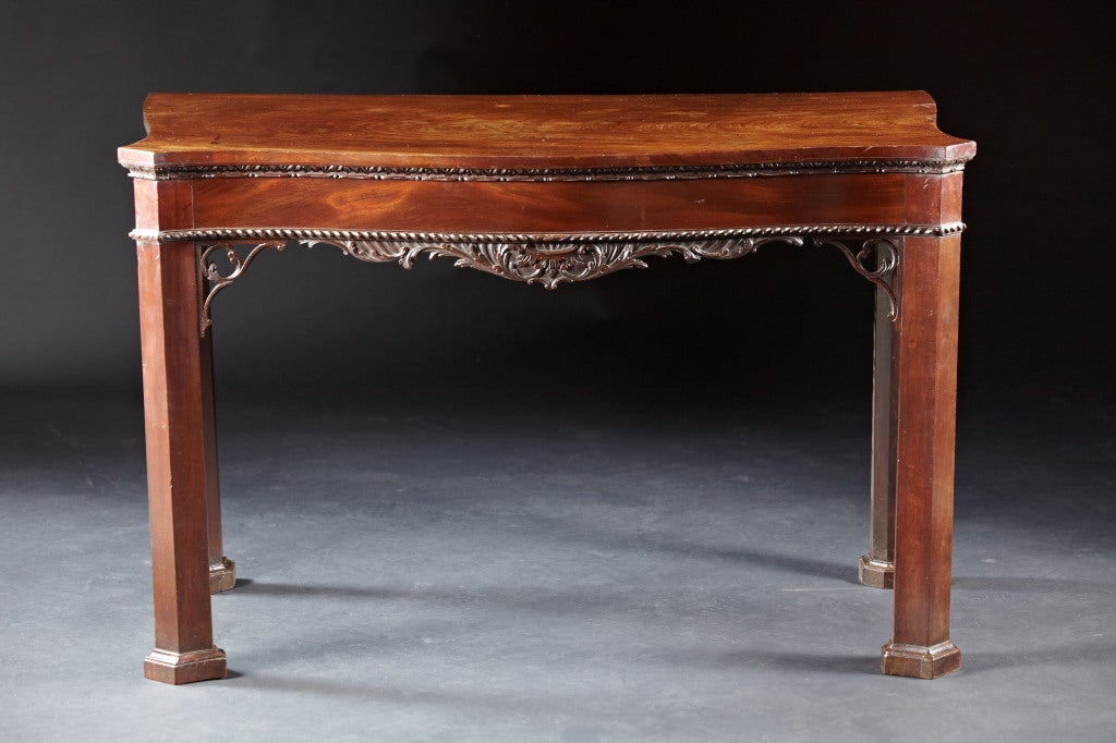 A George II serpentine pier table of the finest quality in the marlborough manner. The single board figural mahogany top conforms to a serpentine shaped case with cyma curved sides. The top molding is carved with  imbricated and punchwork carving