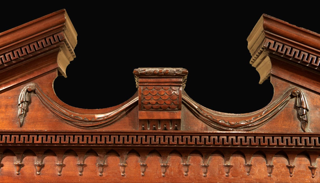 A George III mahogany breakfront bookcase after a design specific to Thomas Chippendale's 