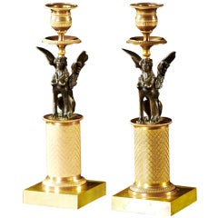A Pair of French Empire Patinated and Gilt Bronze Candlesticks