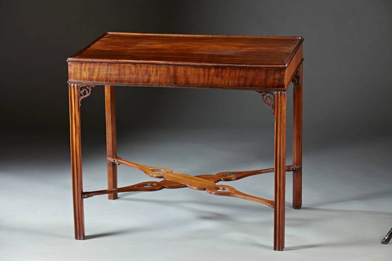 A mahogany silver table with rectangular top with a shallow tray  supported by four molded marlborough legs with pierced filigree returns and joined by a flat pierced cross braced stretcher with heart shaped cut outs.  American or English, circa