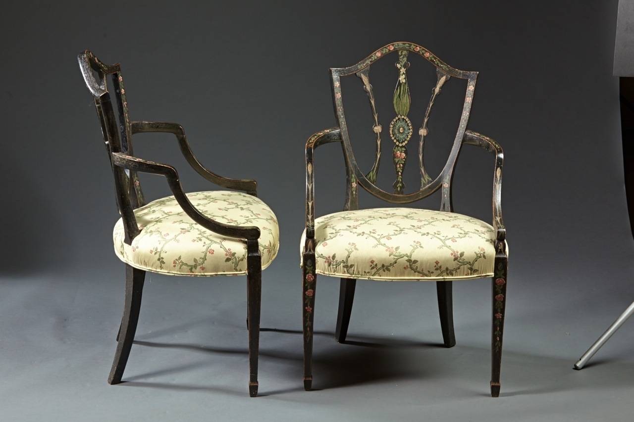 A pair of George III period painted armchairs with shield shaped backs on square tapered legs ending in spade feet; both chairs with refreshed original paint surface, English, circa 1790. Great presence and ready to go!
   