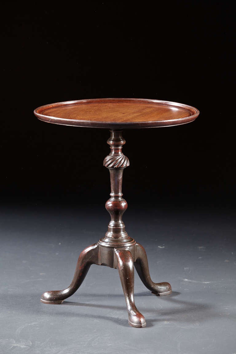 A very rare Newport Wine tasting stand in mahogany with screw on disk top and cabriole legs base. The single board top in choice mahogany with finely turned edge forms a distinctive top. The legs are dovetailed into a circular molded platform. The