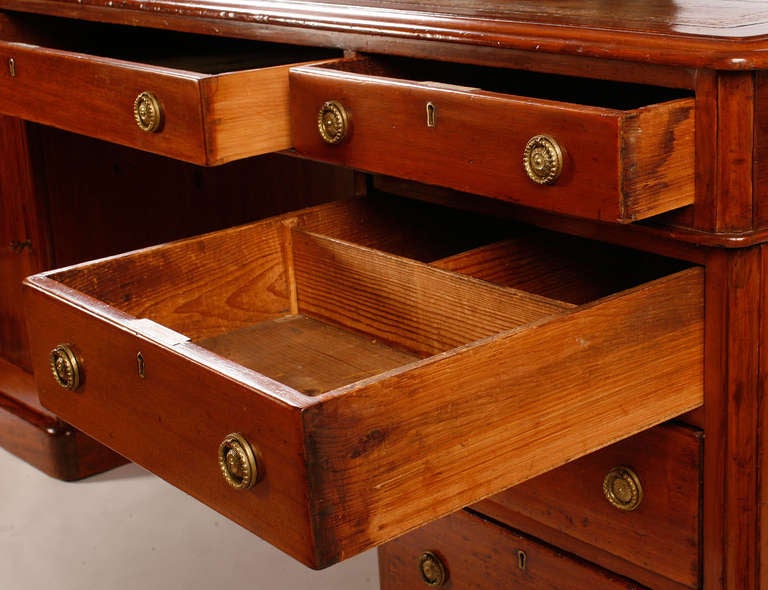 Quite large English Victorian Partners desk with drawers and cupboard doors on both sides, tooled leather top and
a generous size kneehole opening.