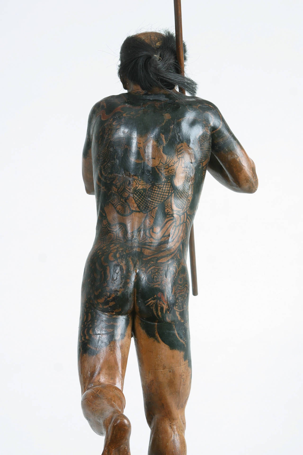 Japanese Iki-ningyo painted life like sculpture of a tattooed man with a fierce
demeanor in an animated pose running with a spear.
Similar examples are owned by the Osaka Museum of History and the
Contemporary Art Museum in Kumamoto. A scholarly