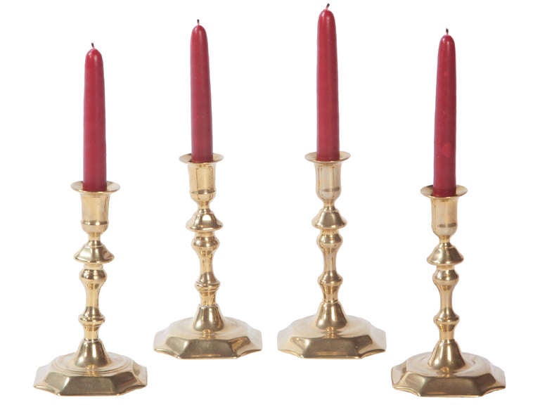 an assembled set of four mid 18th century brass candlesticks
great to use on a period card table with four candle pockets