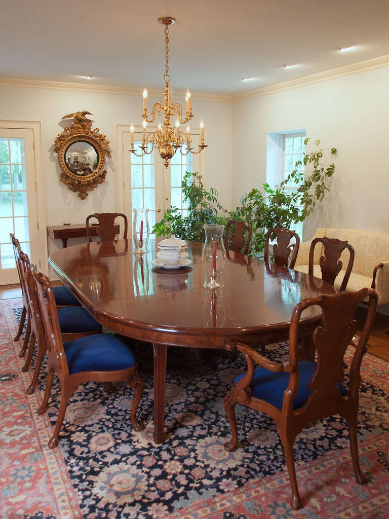 Large mahogany aesthetic round center table with a superbly
carved pedestal. Opening from five and one half feet in diameter
to twenty three feet long with the leaves in and five feet six inches wide. Provenance: from a well-known Academy