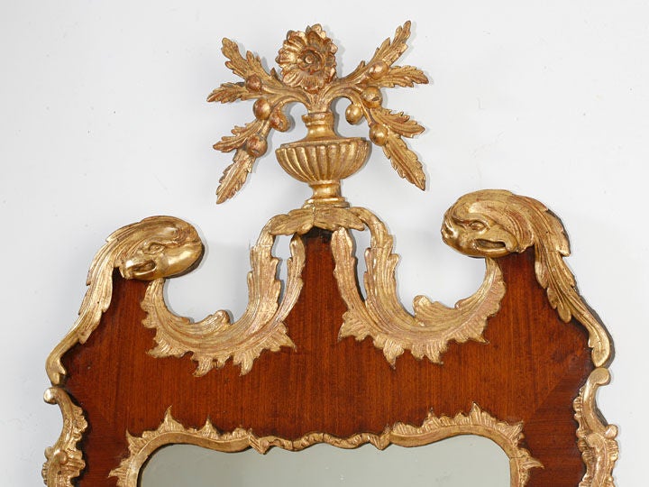 Mahogany and gilt mirror with carved parcel gilt eagles in the crest this mirror is illustrated in Queen Anne & Georgian Looking
Glasses by F Lewis Hinckley on Page 150 and called a Philadelphia 
mirror