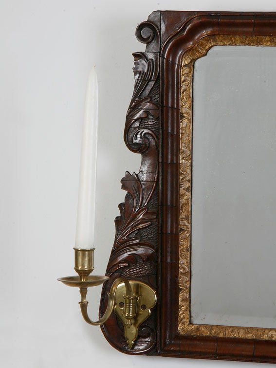 Walnut and gilt over-mantel mirror with carved ends original three
part beveled mirror and brass sconce arms