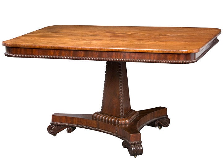 English Regency mahogany breakfast table made with a superb choice

of figured mahogany on a pedestal base.