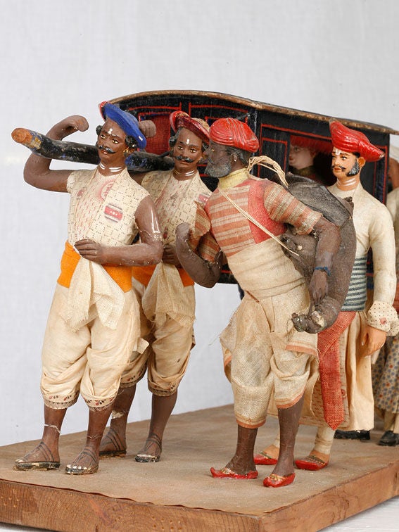 19th Century Indian palanquin with a western passanger and native bearers