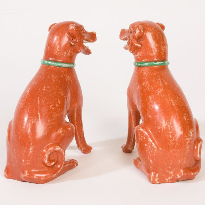 Pair of Export coral ground dogs with smiling faces and green collars