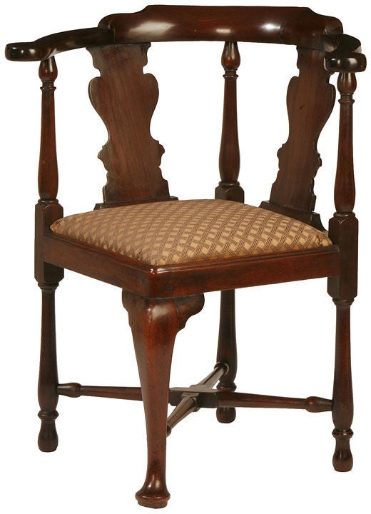 A fine example of a George II corner chair with vase shaped splats a well shaped cabriole front leg, well turned back legs with a turned stretcher