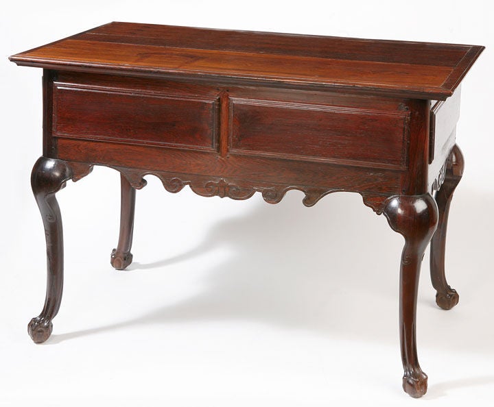Fine Brazilian Jacaranda rosewood two-drawer library table with raised panels,
cabriole legs ending in claw and ball feet with the original rococo drawer handles.