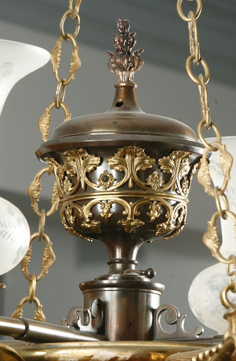 English Regency patinated and gilt bronze chandelier with four lights and argand

glass shades.