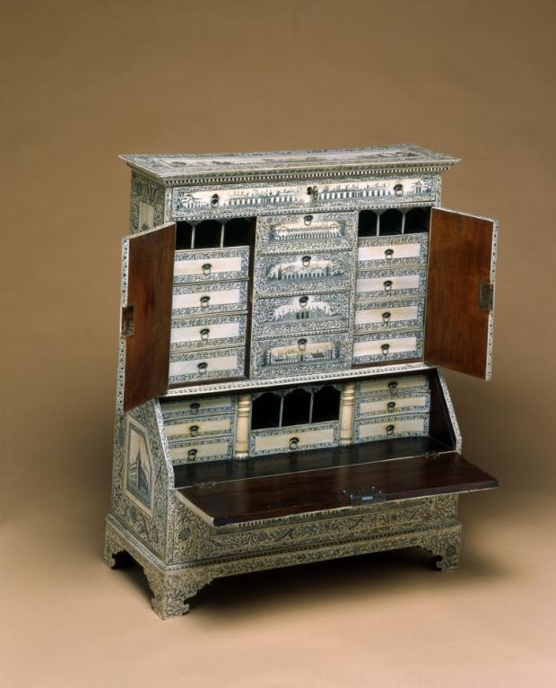 An exceptionally large miniature secretary bookcase in ivory with etched designs.The rectangular cornice with single long apron drawer over two hinged doors enclosing fitted interior, centering four short drawers over base cabinet of one long drawer