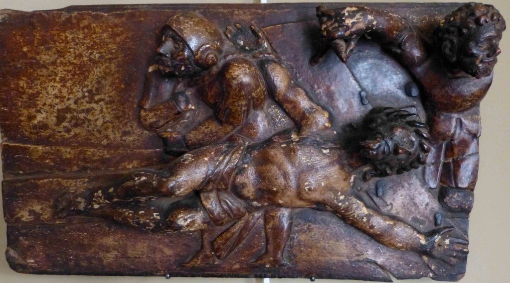 A fine and rare Spanish early 16th century relief carving depicting one of the stations of the cross on chestnut panel with traces of gilding throughout.
