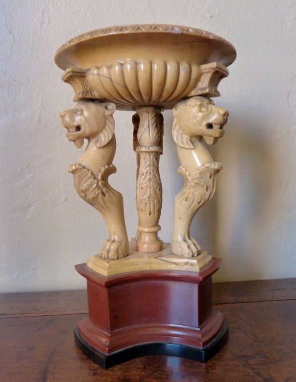 A rare neoclassic Grand Tour carved Siena marble carved tazza resting on an acanthus leaf central support flanked by three lion monopeadia raised on marmo rosso antic base.See Thomas Hope designs using similar lion monopedia on furniture.  Circa 1820