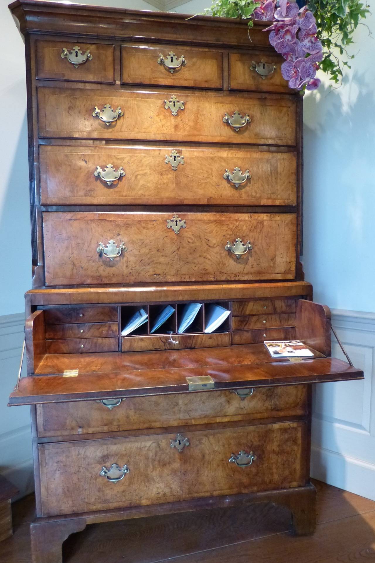 A well figured George II walnut chest on chest with a secretaire drawer on bracket feet. The top section with fluted canted sides incorporating a pull-out secretaire drawer, with original hardware, circa 1740.