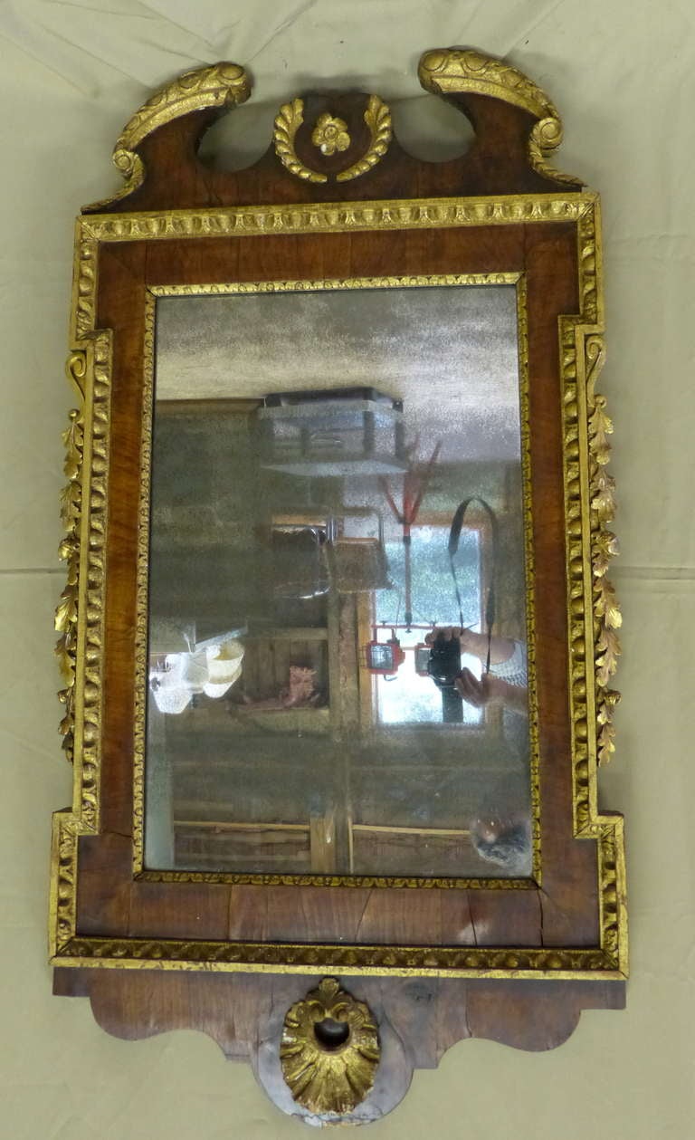 A fine example of an English early 18th century parcel gilt mirror in 