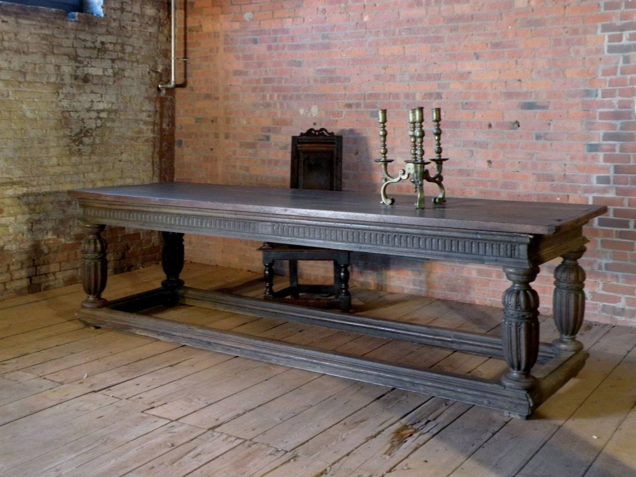Large late Elizabethan dining, center, or library-table of stately elegance and superb proportions and design, with elongated melon-legs. The box stretchers still retain the original moldings, a rare feature in this type of tables.
