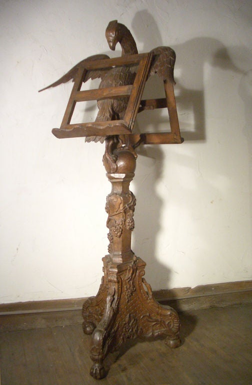 Magnificent, tall floor lectern of outstanding quality, superbly carved and detailed. Double sided lectern supported by a finely detailed eagle, on carved stem and tripod base ending in ball and claw feet.

