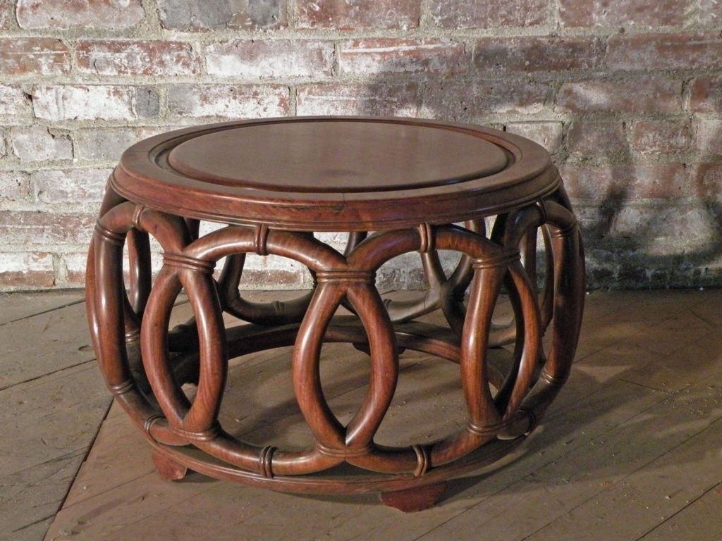 Petit Chinese coffee or side table of interesting geometric design. The round top supported by a base of  interlocking circles, connected at the base by a circular frame on five flattened bun-feet.
