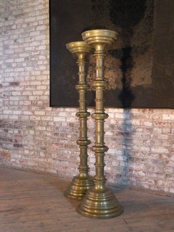 Pair of massive Gothic style brass candelabra of impressive size. Can be electrified or used to hold large pillar candles.
