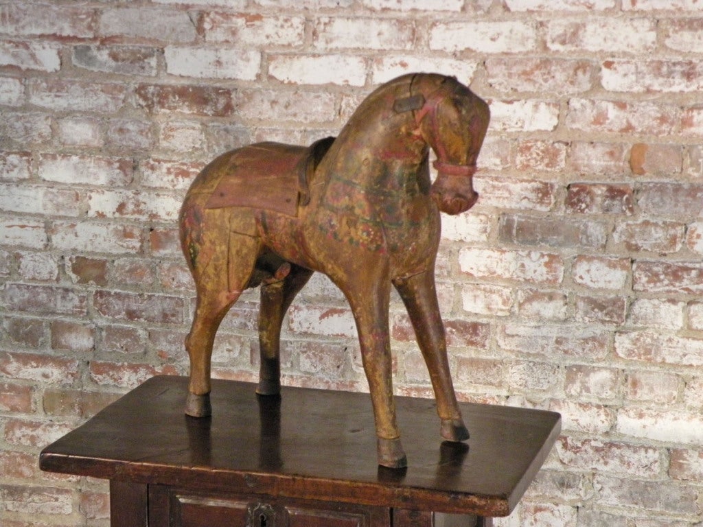 Very decorative figure of a horse, sculpted in a stylized, almost Primitive style with most charming, faded remains of paint.
