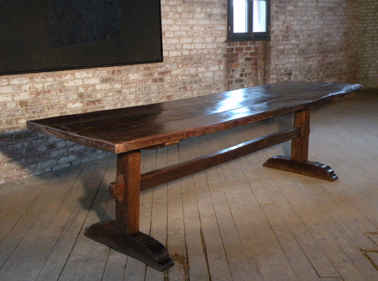 Thick three-plank elm top with narrow breadboard ends, supported by a solid, simple trestle base, Beautiful wear and character.
