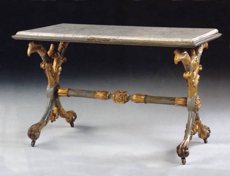 The white marble top supported by two X-form eagle headed legs ending in paw feet and joined by a fluted stretcher, on casters.
Our pieces are left in lived-in condition, pending our custom conservation and polish to preference.
On consignment